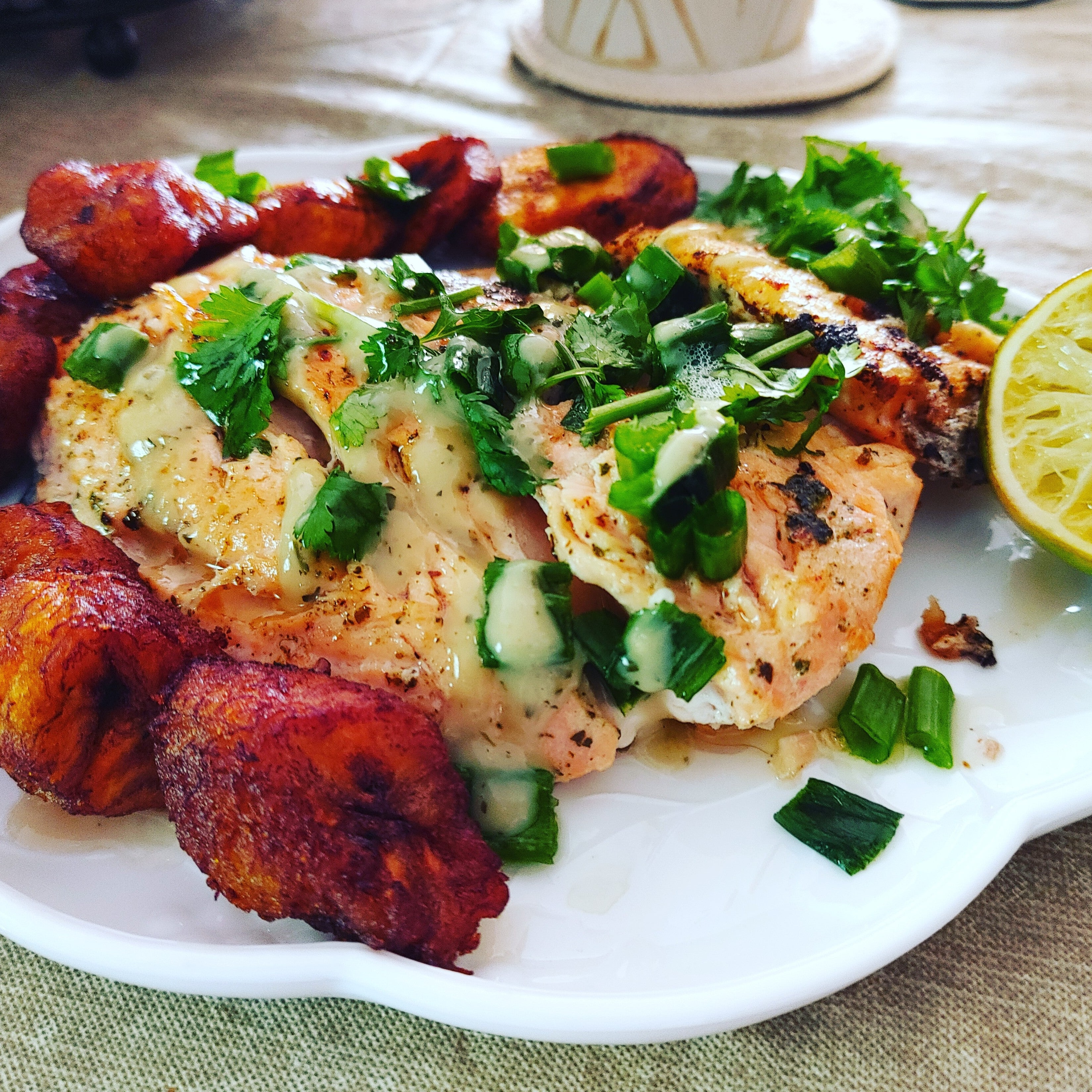 Succulent salmon sweet plantains drizzled with Cilantro Lime sauceains
